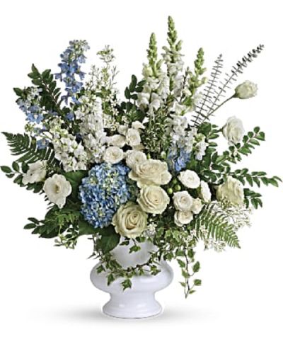 <div class="m-pdp-tabs-description">
<div id="mark-1" class="m-pdp-tabs-marketing-description">A treasured tribute to your beloved, this gorgeously grand bouquet of soft blue hydrangea and pure white roses is reminiscent of a clear sky, a hopeful reminder of life and love.</div>
</div>
<p id="arrngDescp">This beautiful bouquet of light blue hydrangea, white roses, white spray roses, white lisianthus, light blue delphinium, white snapdragons, white stock, and white waxflower is accented with huckleberry, variegated ivy, spiral eucalyptus, dagger fern, and lemon leaf. Delivered in a white designer urn.</p>