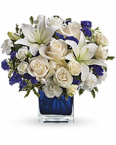 <div class="m-pdp-tabs-description">
<div id="mark-1" class="m-pdp-tabs-marketing-description">Send someone a bit of heaven with this beautiful bouquet. Luxurious crème roses and pure white lilies paint a peaceful picture inside a blue cube.</div>
</div>
<p id="arrngDescp">Crème roses, white asiatic lilies and white miniature carnations are mixed with bursts of purple statice and green pitta negra. Delivered in a glass cube.</p>