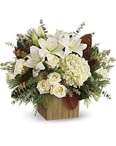 Give the gift of modern winter-white style with this breathtaking bouquet, hand-arranged in a wooden cube.

This winter bouquet includes white hydrangea, white roses, white asiatic lilies, magnolia leaves, seeded eucalyptus, spiral eucalyptus, flat cedar and white pine.
