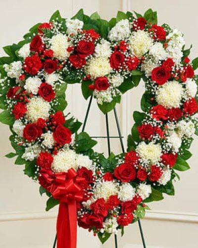 <p>It's not always easy to express your feelings when someone you love has passed on. With this floral tribute, your deepest condolences and undying love are clearly on display. Our expert florists craft red and white roses, football mums, carnations and more into an exquisite open-heart arrangement to help you convey your sympathies. Traditionally sent directly to the funeral home by family members or friends and displayed on a stand.</p>
