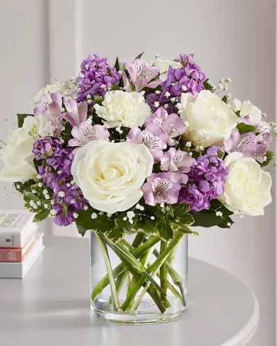 <p>Lovely memories are made with thoughtful gifts for the ones we care about. Our charming bouquet is loosely gathered with a medley of lavender & white blooms. Hand-designed inside a clear cylinder vase with cascading greenery all around, it’s a wonderful way to express the sentiments you have inside your heart.</p>