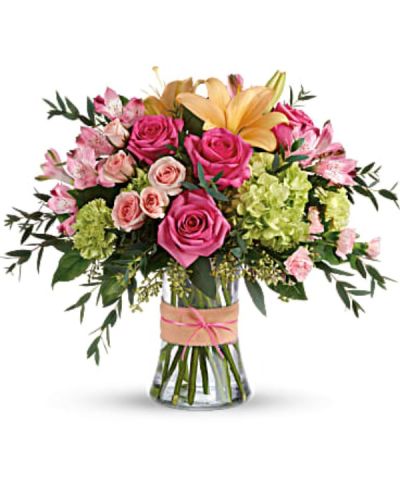 <div id="mark-3" class="m-pdp-tabs-marketing-description">Put a spring in their step with this beautifully blushing bouquet of hot pink roses, soft peach lilies and fresh green hydrangea. Arranged in a graceful vase tied with a charming bow, it's a chic treat for any occasion!</div>
<div id="desc-3">
<ul>
<li>This sweet arrangement features green hydrangea, hot pink roses, pink spray roses, peach asiatic lilies, pink alstroemeria, green carnations, pink miniature carnations, seeded eucalyptus, parvifolia eucalyptus, and lemon leaf.</li>
</ul>
</div>