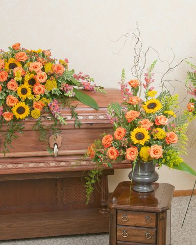 <p>Includes a casket spray, standing spray and urn design in the warm colors of a sunset.</p>