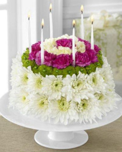 <p>The Wonderful Wishes Floral Cake is set to celebrate their birthday with sweet sentiments blooming with chrysanthemums and carnations. Perfectly arranged in the shape and styling of a colorful birthday cake are white chrysanthemums, green button poms, pale yellow carnations and magenta mini carnations. Presented on a white cake plate, this memorable flower arrangement will add to the festivities of their special day.</p>