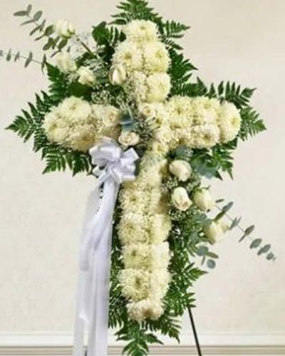 <p>Send a beautiful and striking floral tribute that shows your support and love during this difficult time. This standing spray arrangement in the shape of a cross is created from fresh white roses, football mums, greenery and floral accents. Traditionally sent directly to the funeral home by family members or friends and displayed on a stand.</p>