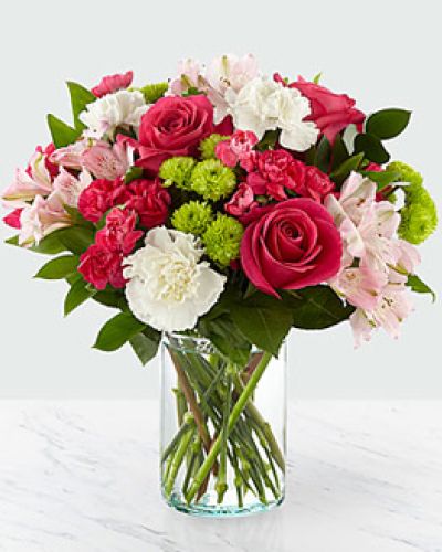 <p>The true beauty of this bouquet is within the sweet colors of the flowers. An array of hot pink roses, pale pink alstroemeria and more are set in a glass cylinder vase, making a wonderful gift to light up the face of its recipient.</p>